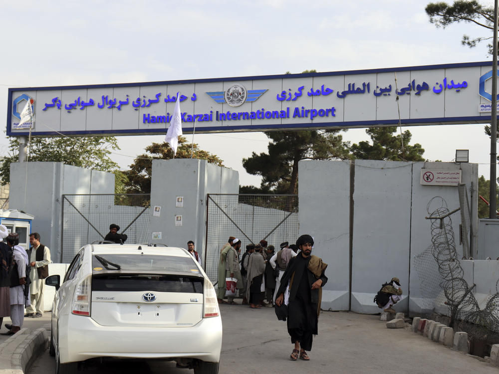 Taliban fighters stand guard in front of the Hamid Karzai International Airport after the U.S. withdrawal in Kabul, Afghanistan.
