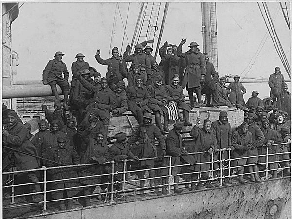 Members of New York's famous 369th Infantry Regiment wave as they come back home from France.