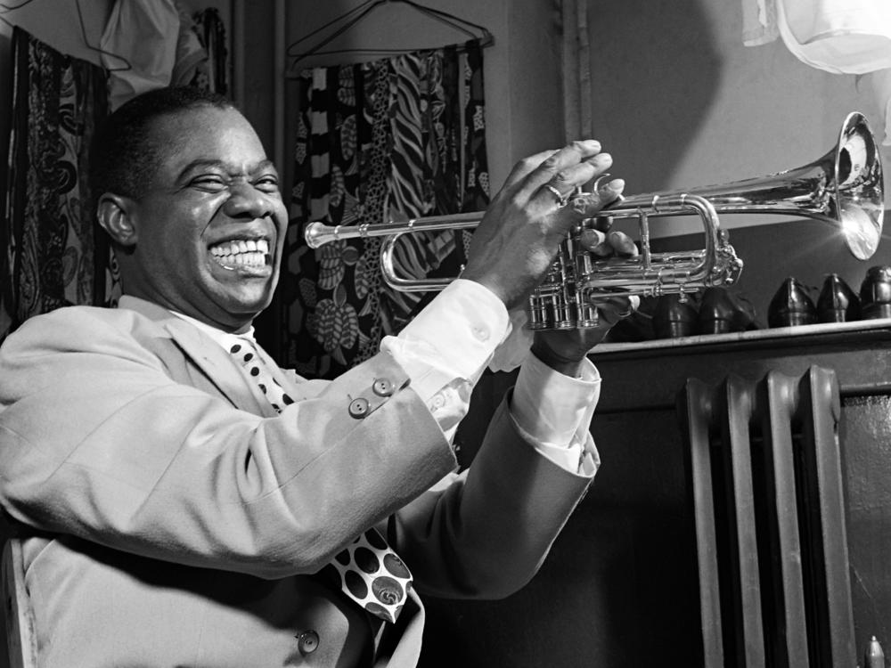 American jazzman Louis Armstrong plays trumpet in his dressing room before a show in 1947 in a New York jazz cabaret. Hurricane Ida destroyed the Karnofsky Shop in New Orleans, which was a formative influence on Armstrong's musical life.