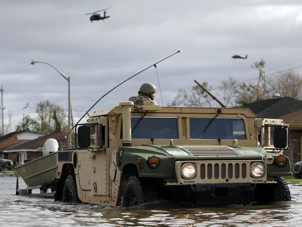 A National Guard vehicle drives through flooded LaPlace, La., on Monday. Emergency and first responder teams, including the U.S. Coast Guard and National Guard, continue operations on Tuesday.