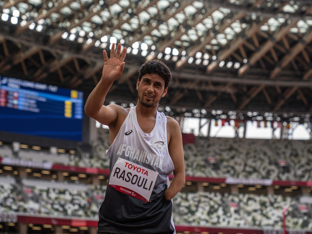 Hossain Rasouli of Team Afghanistan waves after competing in the Men's Long Jump-T47 Final at the Tokyo Olympic Stadium on Tuesday. He and teammate Zakia Khudadadi managed to get to Tokyo despite the turmoil in their home country.