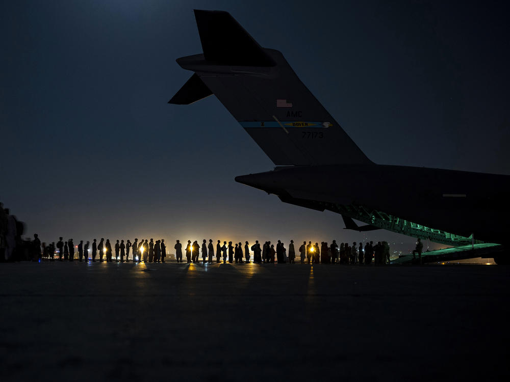 A U.S. Air Force air crew prepares to load evacuees aboard a C-17 aircraft at Hamid Karzai International Airport in Kabul, Afghanistan, on Aug. 31. Several public school students from Sacramento, Calif., remain in Afghanistan since the U.S. evacuation ended.