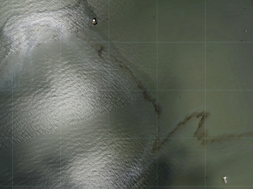 Photos captured by National Oceanic and Atmospheric Administration aircraft Tuesday, Aug. 31, 2021 and reviewed by The Associated Press show a miles long black slick floating in the Gulf of Mexico near a large rig marked with the name Enterprise Offshore Drilling.