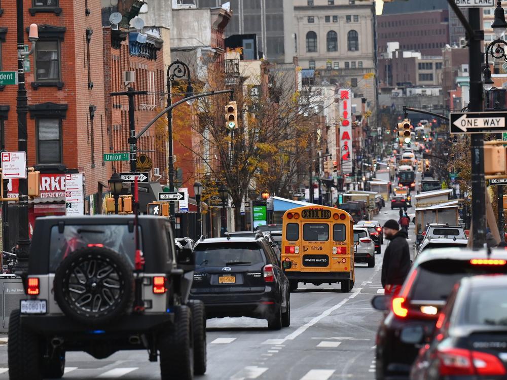 A school bus drives down a street on the first day of school reopening on December 7, 2020 in the Brooklyn borough of New York City.