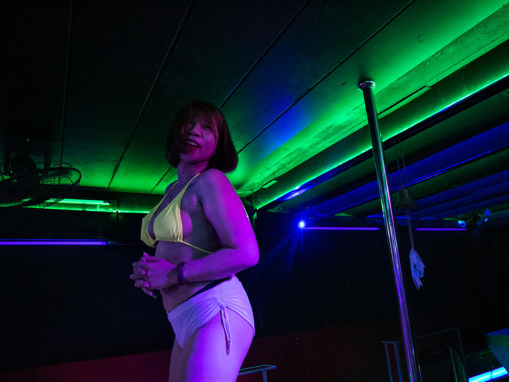 M. dances at a go-go bar. She was working as a topless dancer — and also as a sex worker — in the tourist city of Pattaya, Thailand, until the bar closed down in January. She decided to return to her hometown to look for work in a different sector.