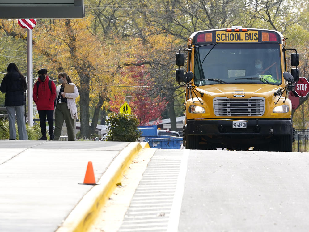 Students wear mask as they arrive at school for in-person learning at Holmes Middle School in Wheeling, Ill., on Oct. 21, 2020. Students in Illinois schools will be able to take up to five excused mental or behavioral health days beginning in January 2022.