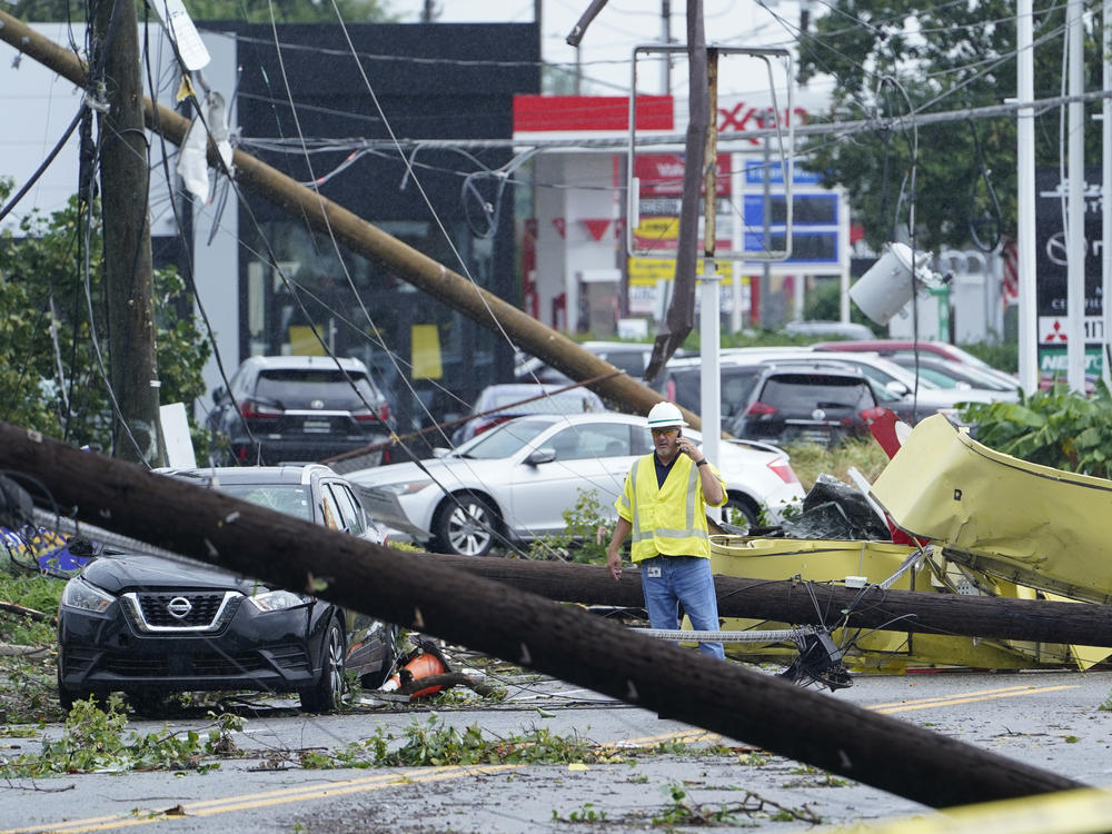 A worker surveys damage Wednesday in Annapolis, Md., after severe weather moved through the area.