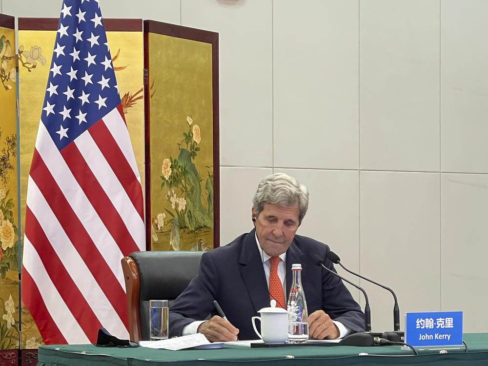 In this photo provided by the U.S. Department of State, U.S. Special Presidential Envoy for Climate John Kerry attends a meeting with Chinese Foreign Minister Wang Yi via video link in Tianjin, China, Wednesday, Sept. 1, 2021. Wang warned Kerry on Wednesday that deteriorating U.S.-China relations could undermine cooperation between the two on climate change.