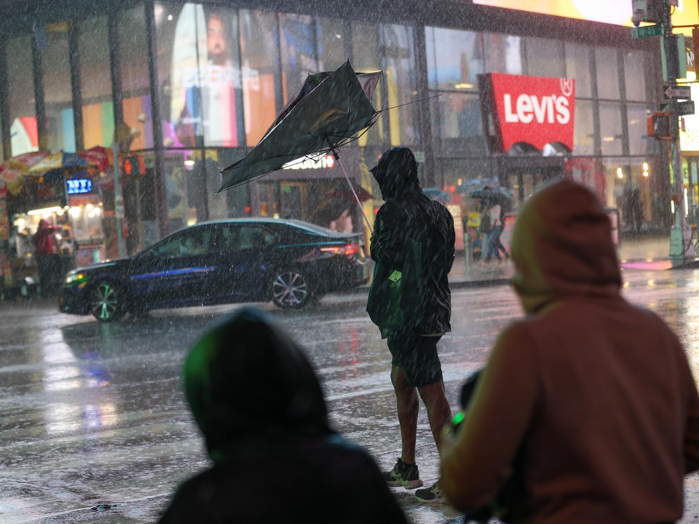 The storm doesn't deter some pedestrians Wednesday in New York. Floodwaters caused travel delays throughout the city.