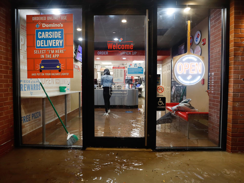 Floodwaters make their way into a Domino's pizza restaurant Wednesday in Hoboken, N.J.