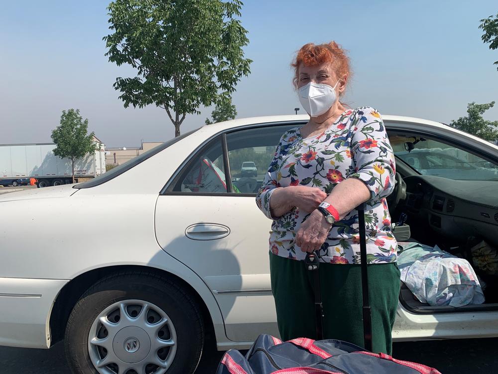 Mimi Routh, 79, unloads a suitcase from her car after evacuating from the Tahoe Senior Plaza to a shelter in nearby Gardnerville, Nev.