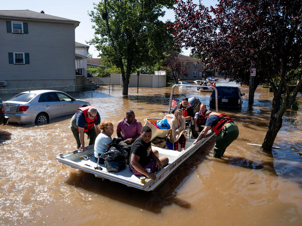 Members of the fire department in Lodi, N.J., perform water rescues Thursday on residents trapped after torrential rains from the remnants of Hurricane Ida.