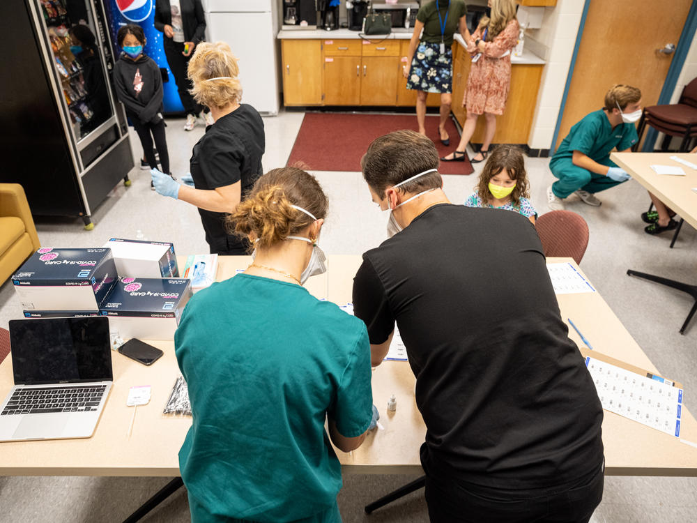 Nurses work at a COVID-19 testing day for students and school faculty at Brandeis Elementary School on in Louisville, Ky.