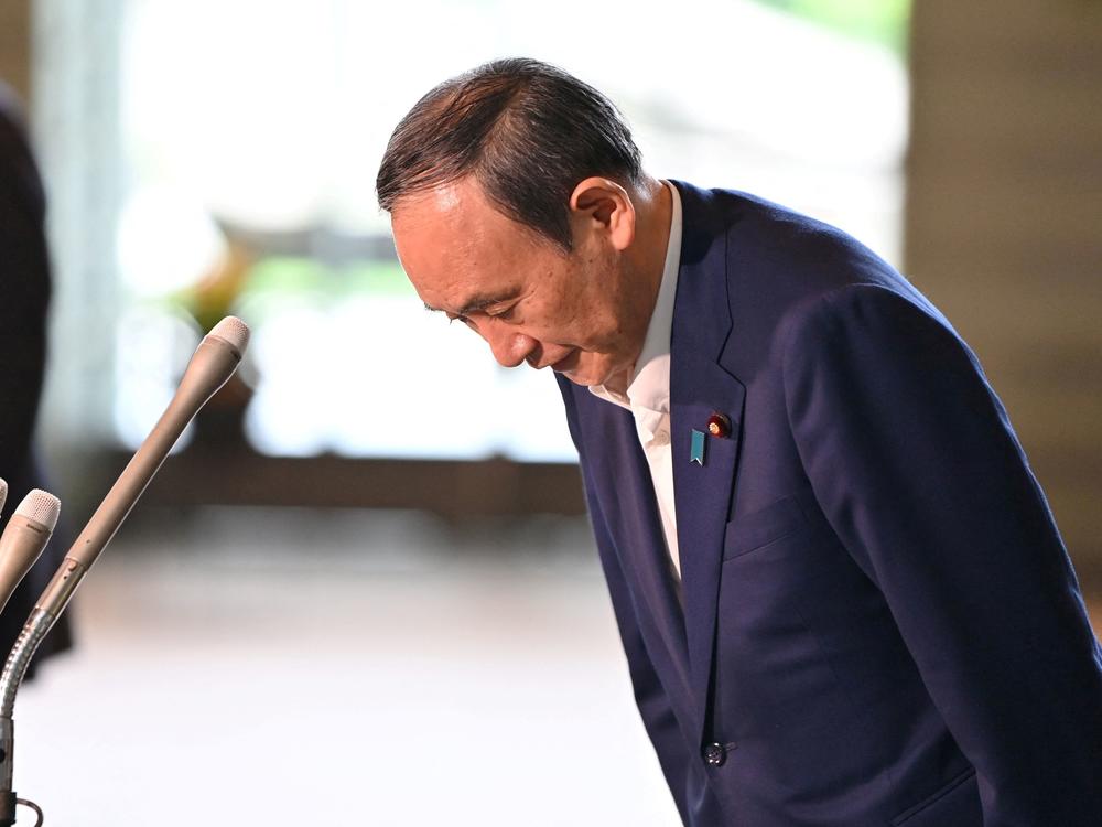 Japan's Prime Minister Yoshihide Suga bows during a press conference at the prime minister's office in Tokyo on Friday, following his announcement that he will not seek reelection for Liberal Democratic Party leadership this month.
