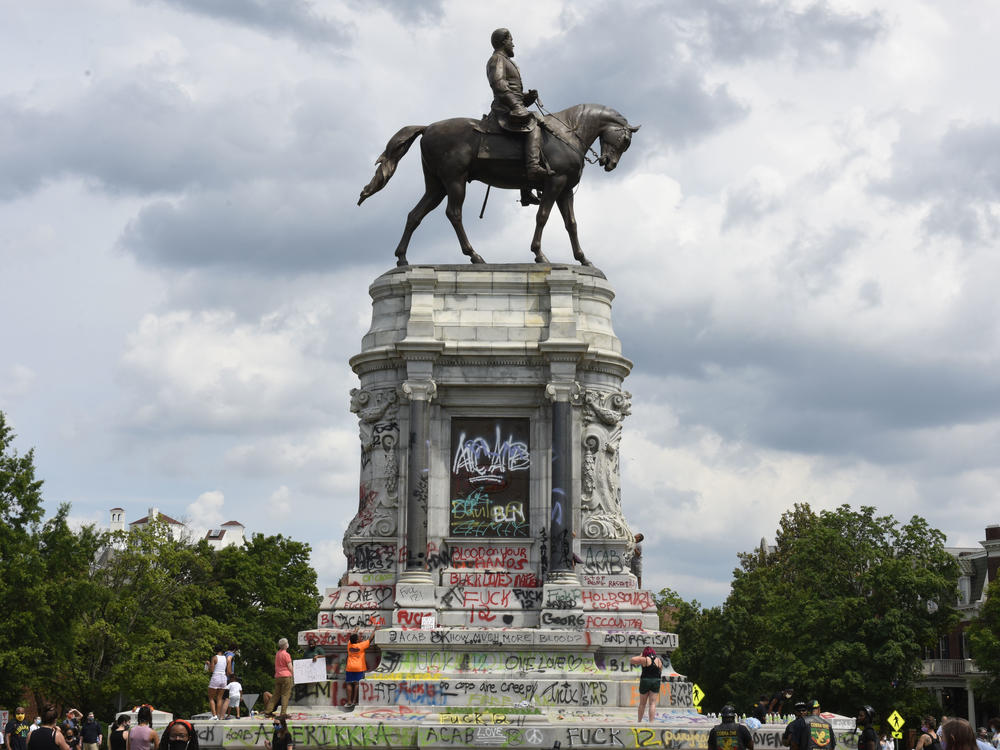 Protesters climb on the base of the statue of Confederate General Robert E. Lee on Monument Avenue on June 6, 2020 in Richmond, Virginia amid continued protests over the death of George Floyd in police custody. The statue is set to be taken down on Sept. 8, 2021.