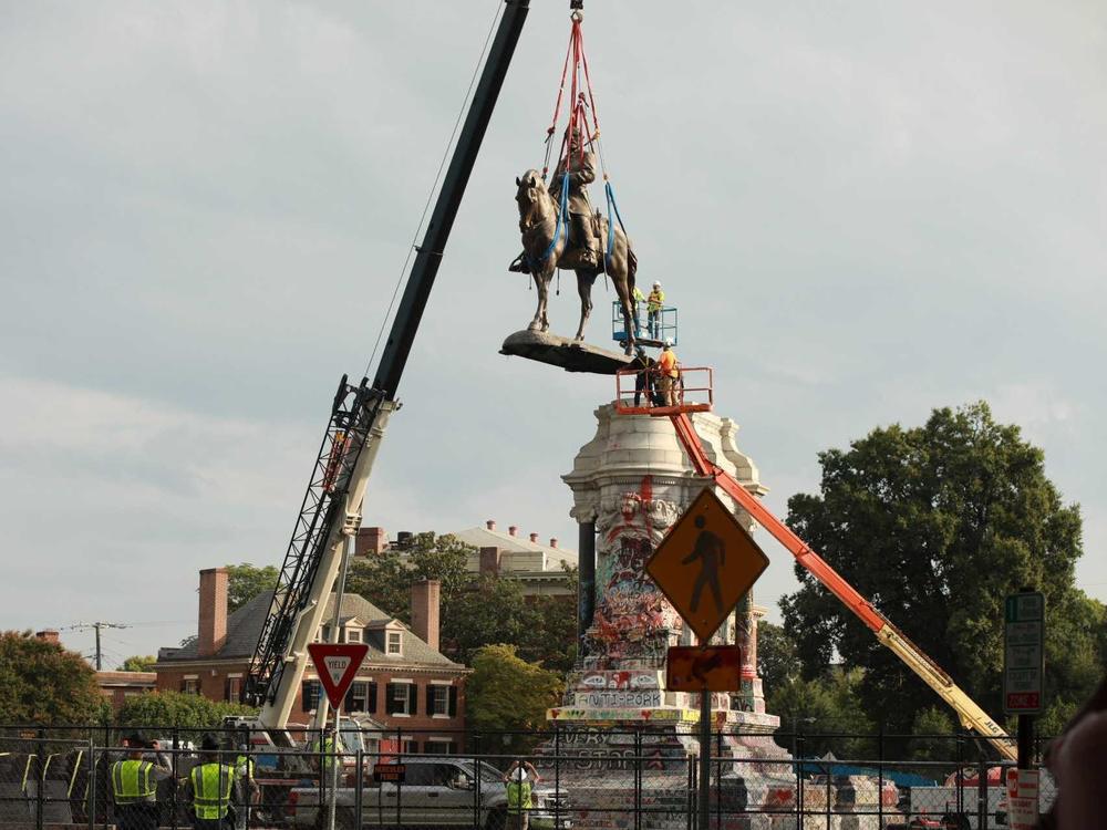 The statue of Confederate Gen. Robert E. Lee is removed from its pedestal Wednesday in Richmond, Va.