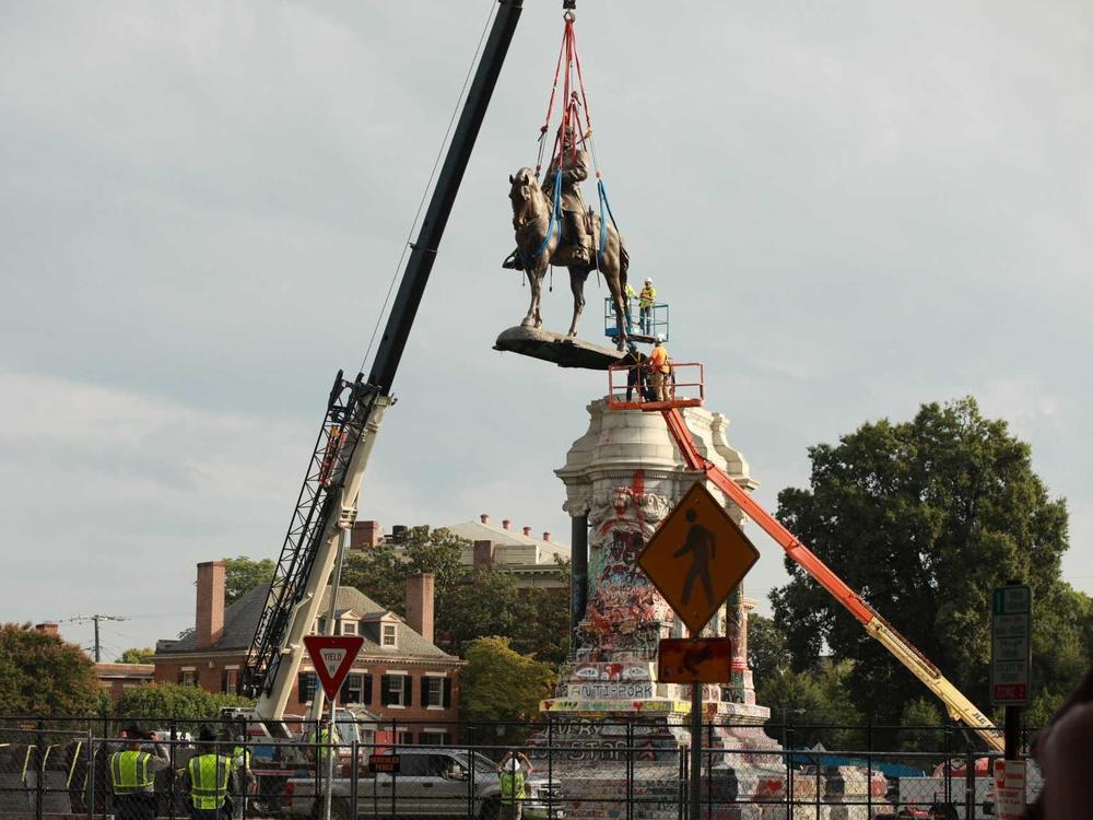 The statue of Confederate Gen. Robert E. Lee is removed from its pedestal Wednesday in Richmond, Va.