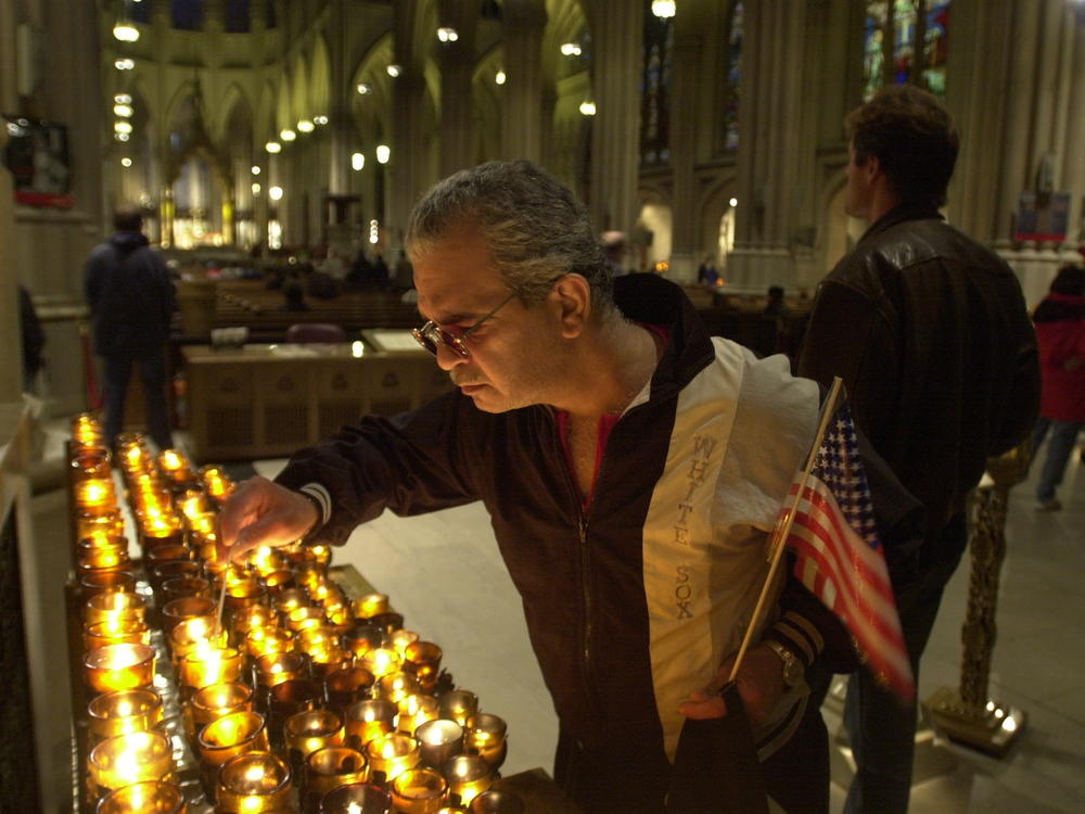 A man in New York City lights a candle on Sept. 14, 2001, for the victims of the Sept. 11 terrorist attacks.