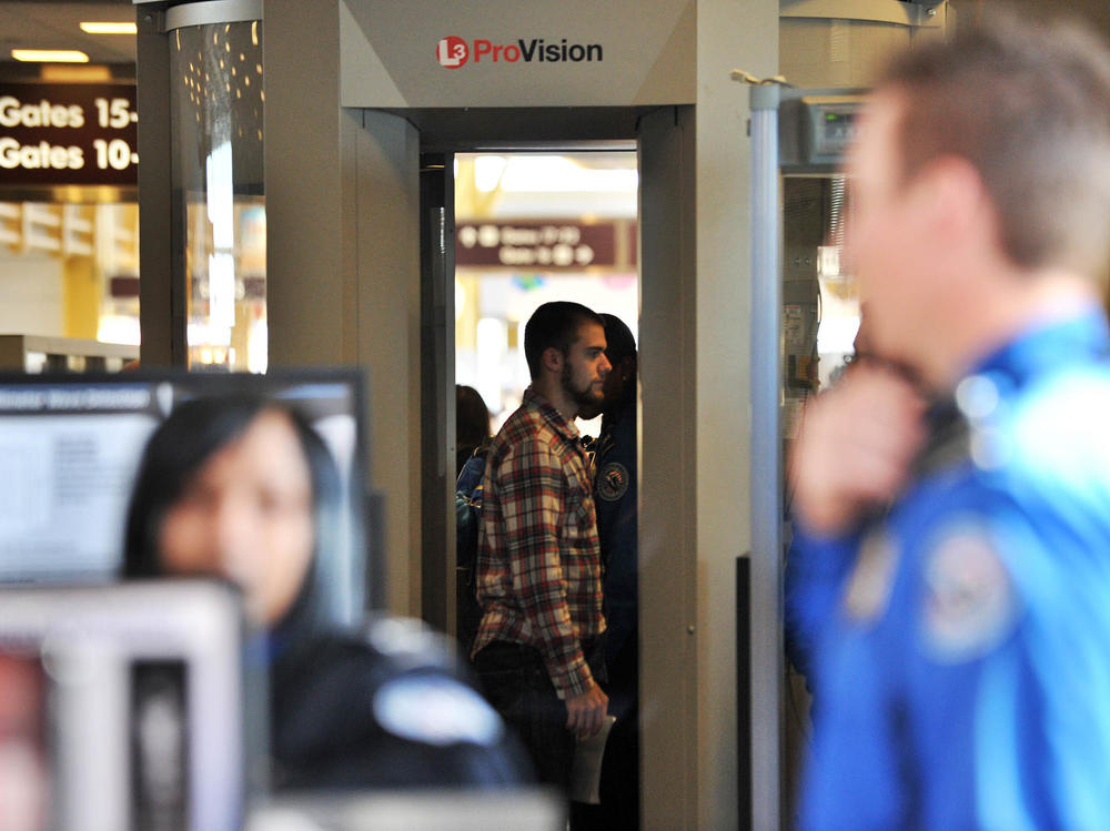 A passenger goes through a full-body scanner at Reagan National Airport in Washington, D.C., on Nov. 24, 2010.