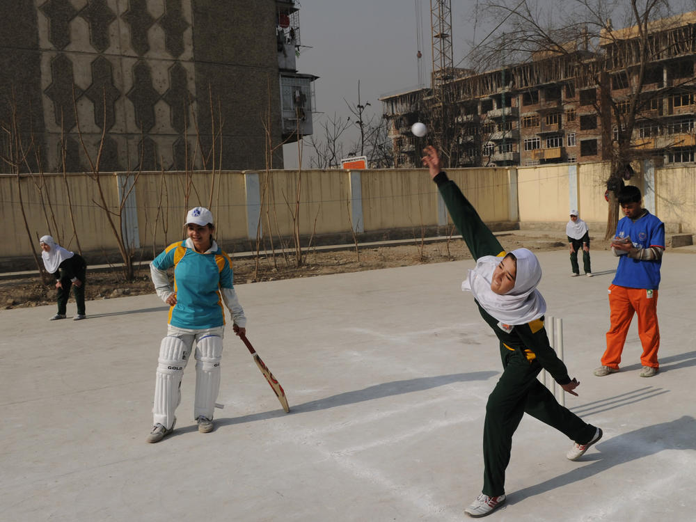 Afghan girls play cricket on school grounds in Kabul in 2010. At the time, Afghanistan was set to select its first national women's cricket team. But a Taliban official now reportedly says women won't be allowed to play it and other sports.