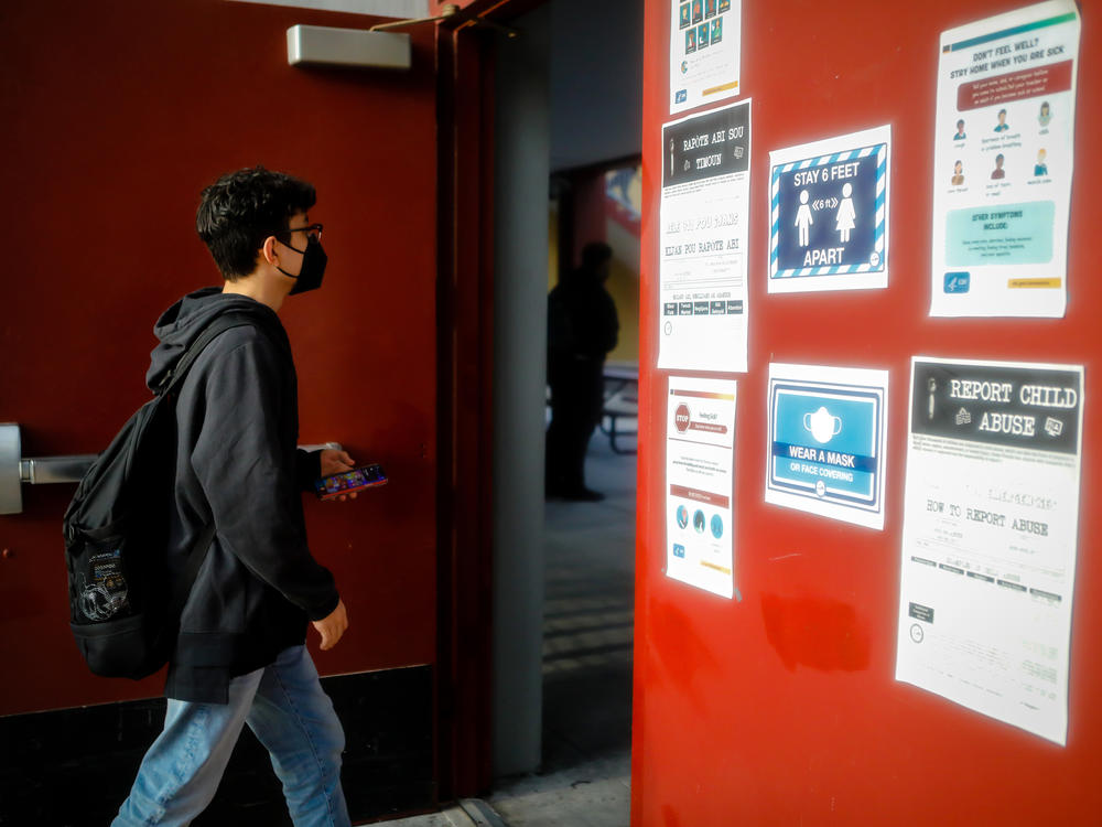 A student arrives for the first day of classes on Aug. 23 at a public school in Miami Lakes, Fla.