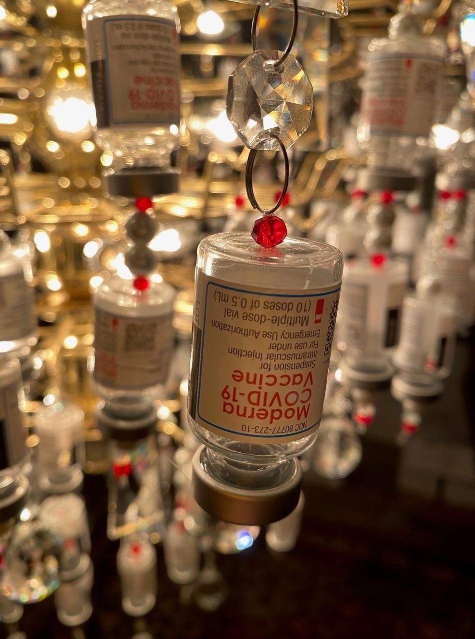 Laura Weiss used 271 glass vials of the Moderna vaccine and about 10 of the smaller Johnson & Johnson bottles to decorate the bottom tier of the Light of Appreciation.