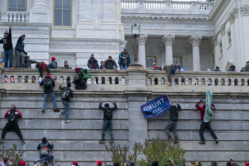 Rioters climb the west wall of the the U.S. Capitol in Washington on Jan. 6.
