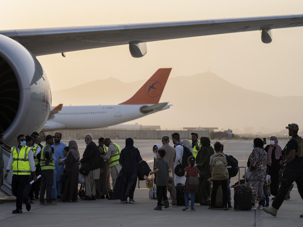 Passengers board a Qatar Airways aircraft at the airport in Kabul, Afghanistan on Thursday.