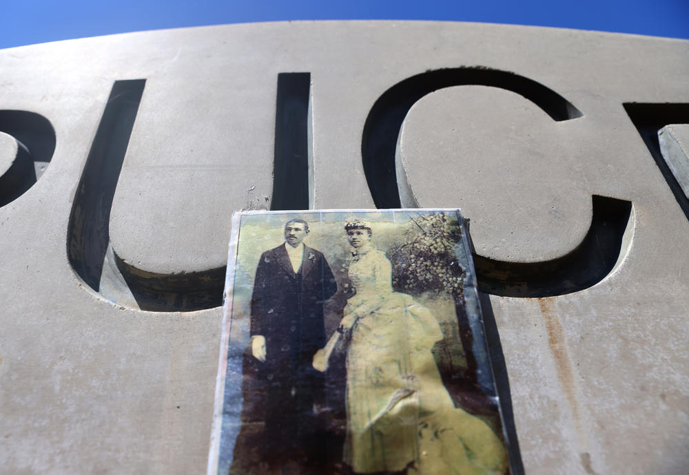 A photo of Charles and Willa Bruce is attached to a plaque marking Bruce's Beach in April in Manhattan Beach.