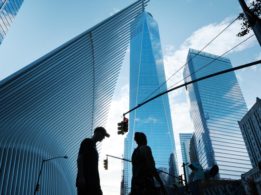 People walk near the sight of Ground Zero and the One World Trade Center on Aug. 30. The Wall Street neighborhood changed drastically after the 9/11 attacks as banks moved out of what had long been their home.