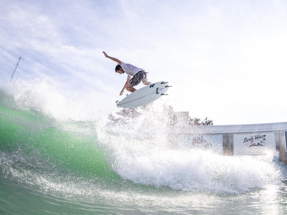 Texas surfer Jacob Williams catches big air in Waco, Texas, where artificial waves are generated by compressed air and a computer.