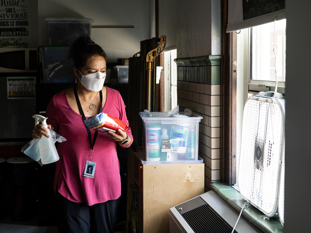 Before classes begin for the day, elementary music teacher Penelope Quesada gathers her most commonly used cleaning supplies and places them around the classroom in places of convenience.