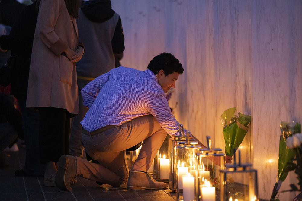 Charlie Greene places flowers for his father Donald Greene, who perished on Flight 93, during a ceremony Friday at Flight 93's Memorial Plaza in Shanksville, Pa.