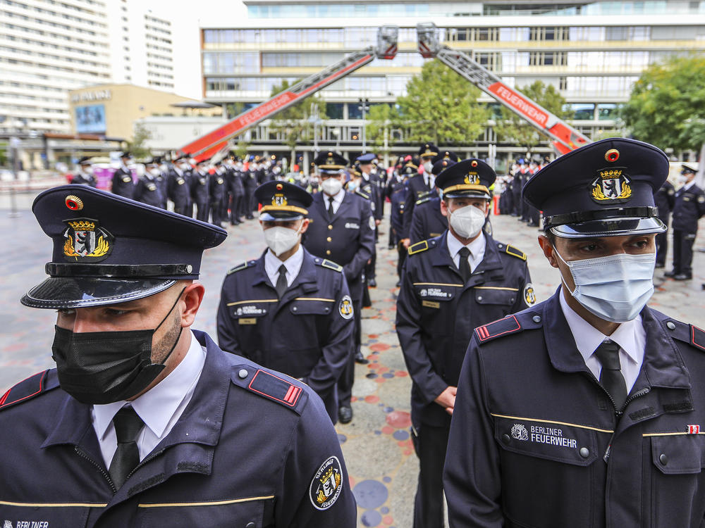 Members of the Berlin city fire department attend a ceremony Saturday near the Breitscheidplatz memorial to commemorate fellow firefighters and other victims killed in the 9/11 terror attacks in New York City.