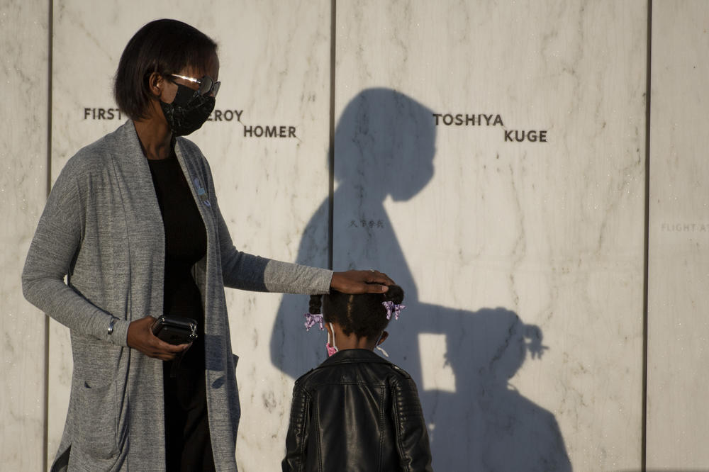 An attendee puts her hand on the head of a child at the Flight 93 National Memorial in Shanksville.