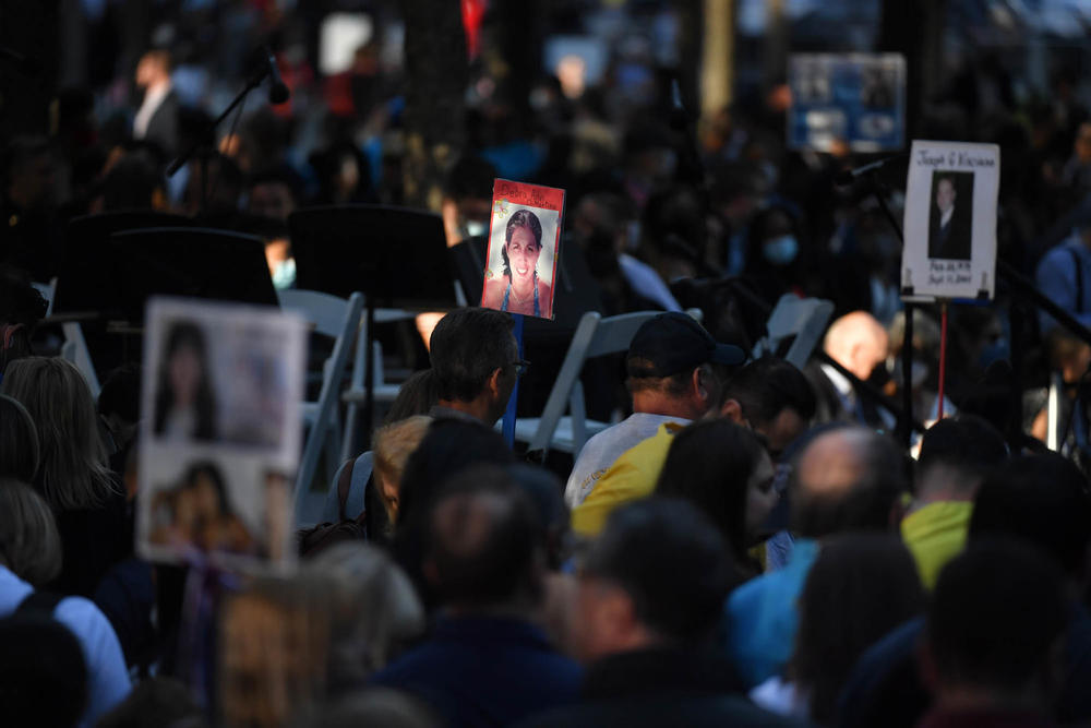 Family and friends carry photos of some of the more than 2,600 victims to the ceremony commemorating the 20th anniversary of the 9/11 attacks on the World Trade Center.