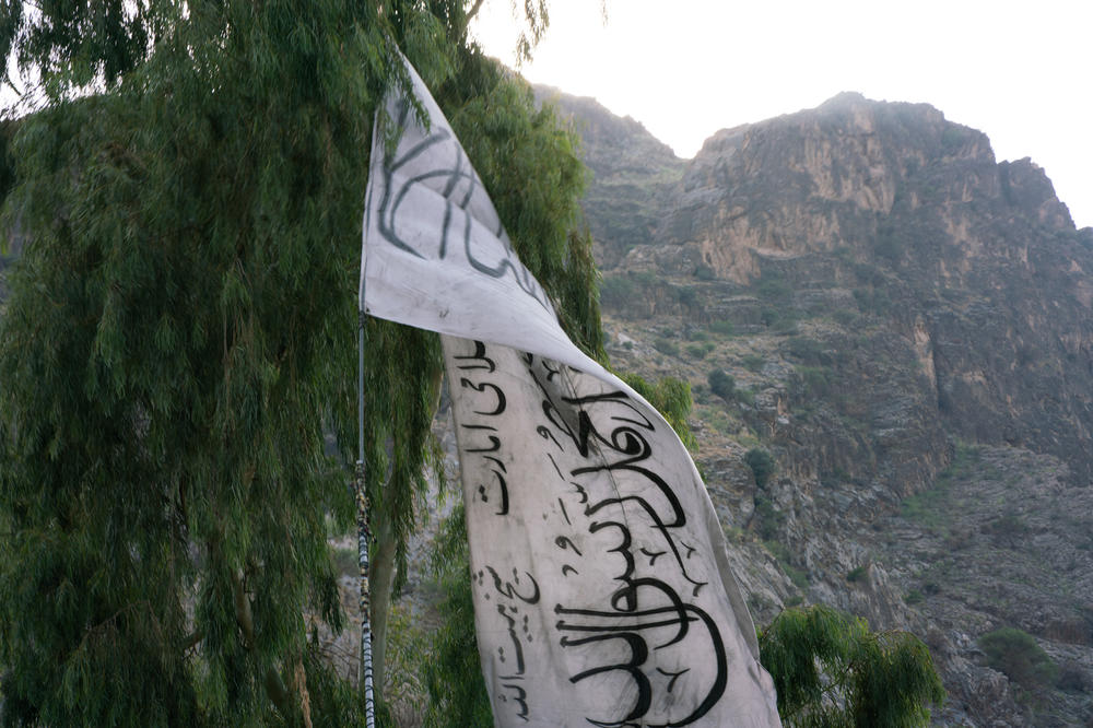 The Taliban flag hangs on the Afghanistan-Pakistan border, backdropped by the mountains of Pakistan's Khyber Pakhtunkhwa province.