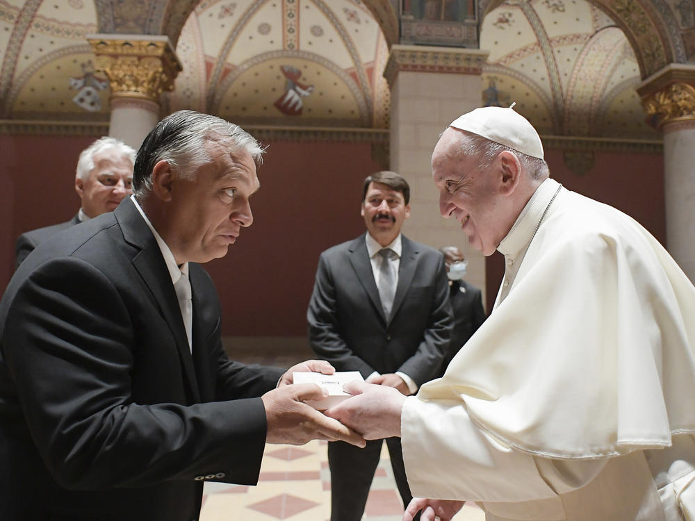 Pope Francis exchanges gifts with Hungarian Prime Minister Viktor Orban, at Budapest's Museum of Fine Arts on Sunday. Francis is opening his first foreign trip since undergoing major intestinal surgery in July, embarking on a four-day, two-nation trip to Hungary and Slovakia.
