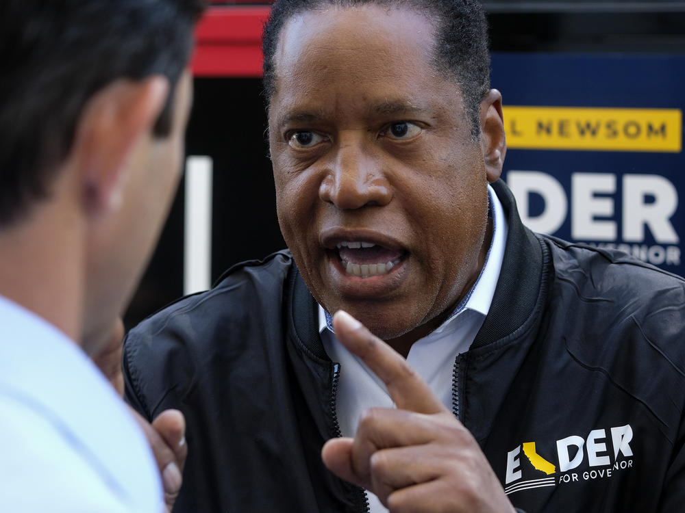 Republican conservative radio show host Larry Elder argues with a TV reporter in an interview Monday after visiting Philippe the Original deli during the campaign for the California gubernatorial recall election in Los Angeles.