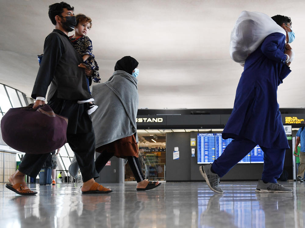 Afghan refugees arrive at Dulles International Airport near Washington, D.C., on Aug. 27 after being evacuated from Kabul following the Taliban takeover of Afghanistan.