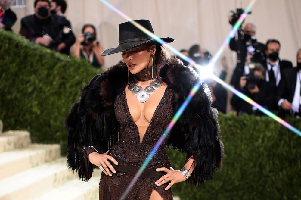 Jennifer Lopez wears a David Koma dress with a cowboy hat.