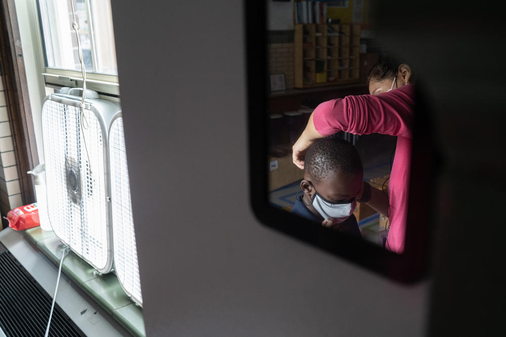 Quesada spends some class time helping students adjust their masks or replacing them if they need new ones.