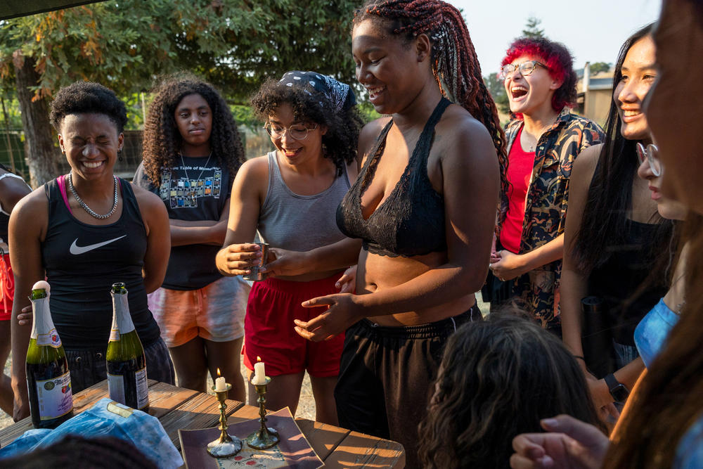 Kenya, Zohara, Maia, Satya, Ollie, Natalie, and Kaila say Hebrew prayers while lighting the Shabbat candles on Friday evening.