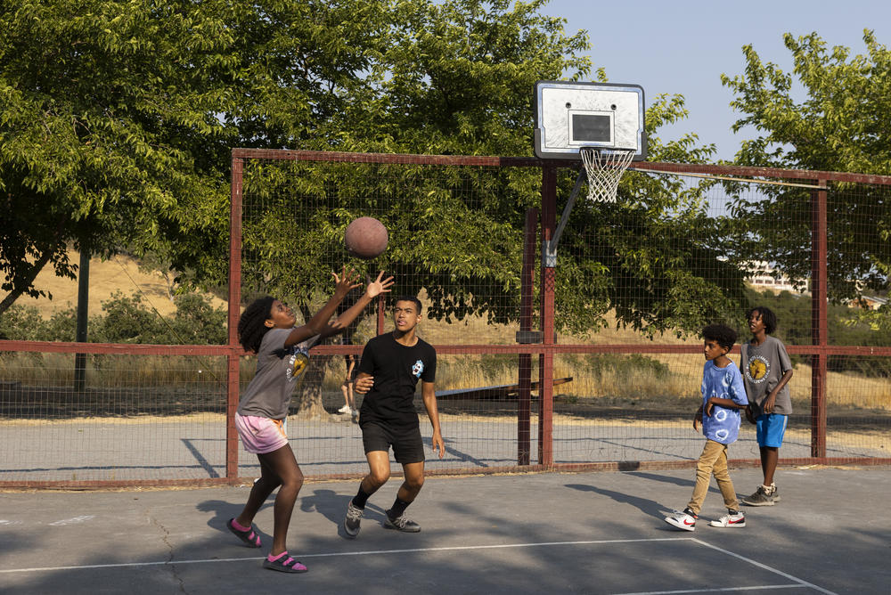 Zohara, Jacob, Solomon and Abelli play basketball together before dinner.