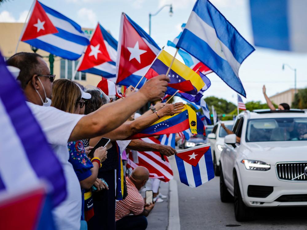 People hold Cuban, Venezuelan and Nicaraguan flags during a protest showing support for Cubans demonstrating against their government in Miami on July 18. The US. Latino population has grown significantly in the last decade.