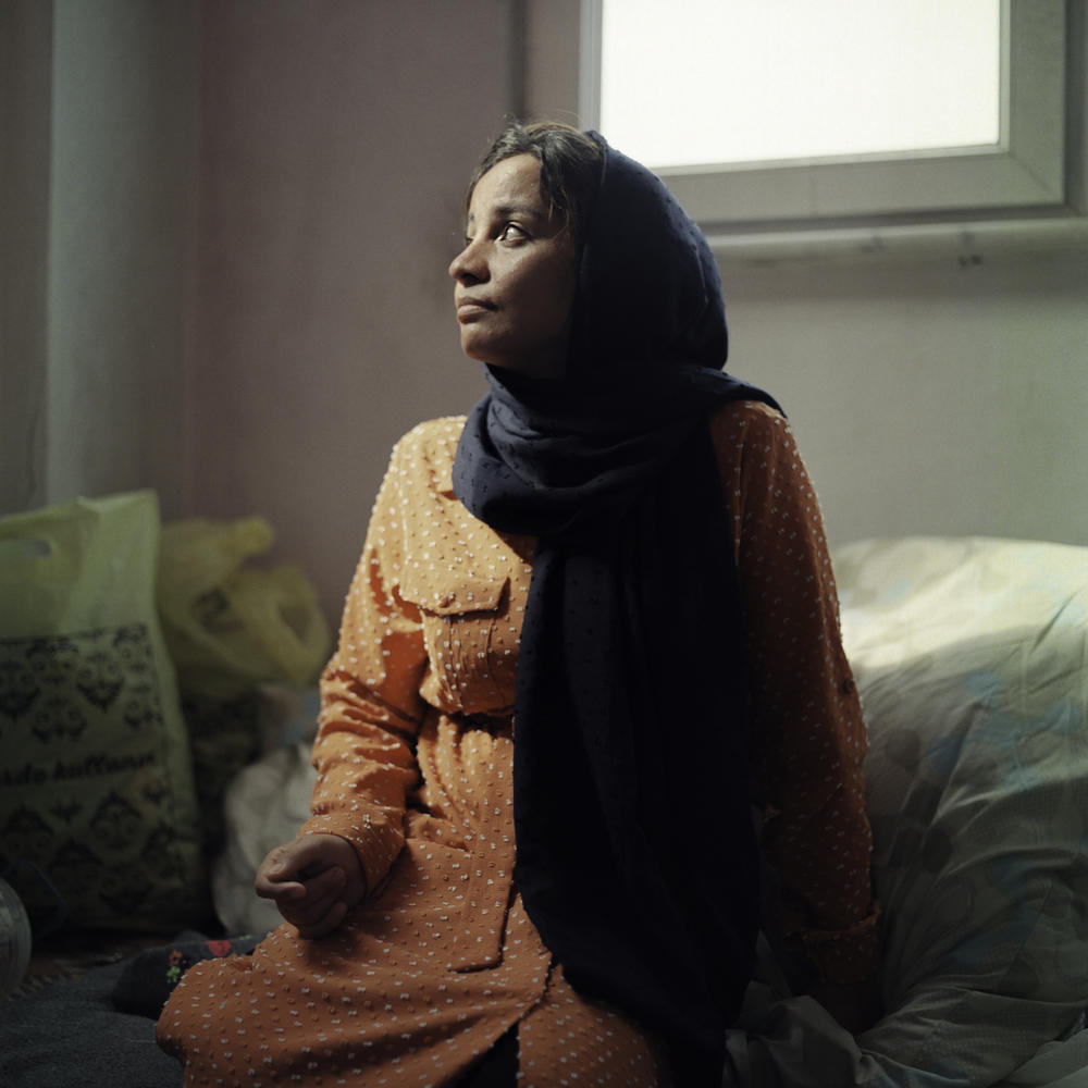 Mahbube Hussaini, 25, was born in Iran to Afghan refugee parents. Because her family was not formally registered to live in Iran, she was unable to attend school there. These days, 9-year-old Elisa helps her practice her handwriting in a spare notebook.