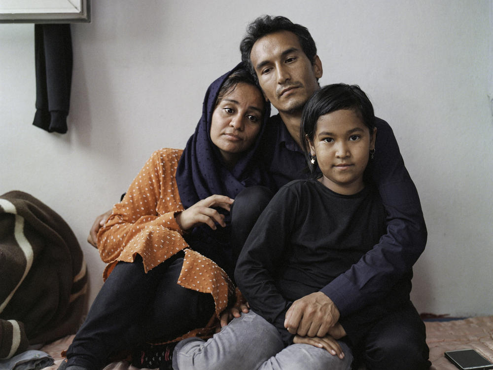 Sayyid Ali Hussaini (center), his wife Mahbube and daughter Elisa sit together in the Turkish city of Trabzon. Originally from the northern Afghan city of Mazar-e-Sharif, the family fled Taliban advances over the summer and arrived in Turkey last month.