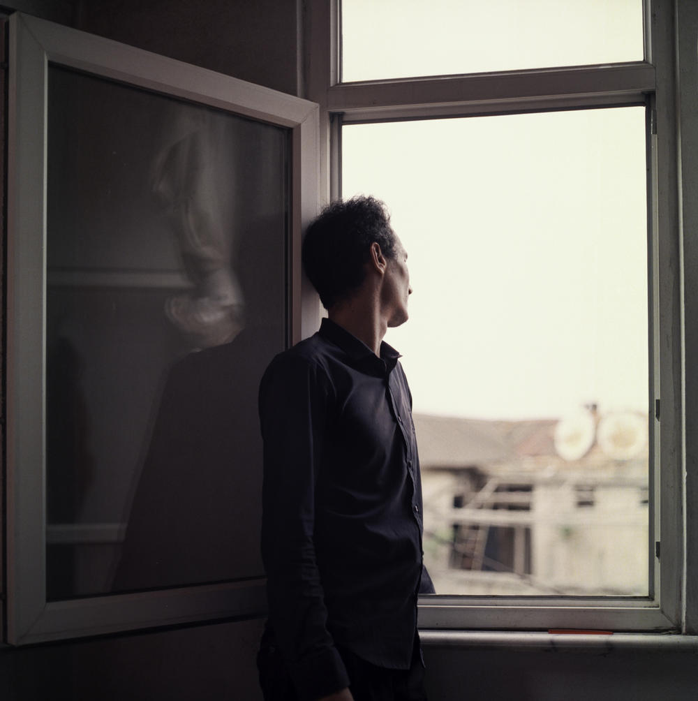 Sayyid Ali Hussaini looks through a window in Trabzon. Originally from the northern Afghan city of Mazar-e-Sharif, he and his family fled Taliban advances over the summer and arrived in Turkey last month. 