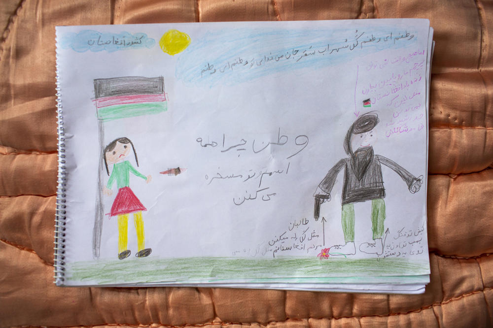 A drawing by 9-year-old Elisa Hussaini is accompanied by text explaining her feelings about Afghanistan. In the center of the page, she writes, 