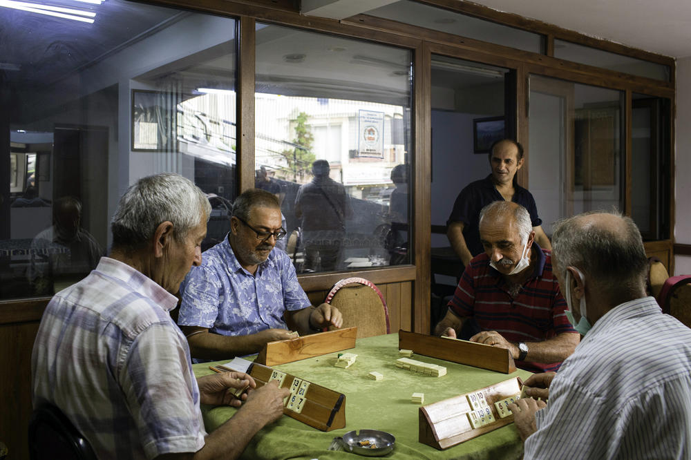 Men are playing a Turkish tile game called Okey in a teahouse in Trabzon. One of them wonders out loud, why wouldn't Afghans stay in their country and fight?